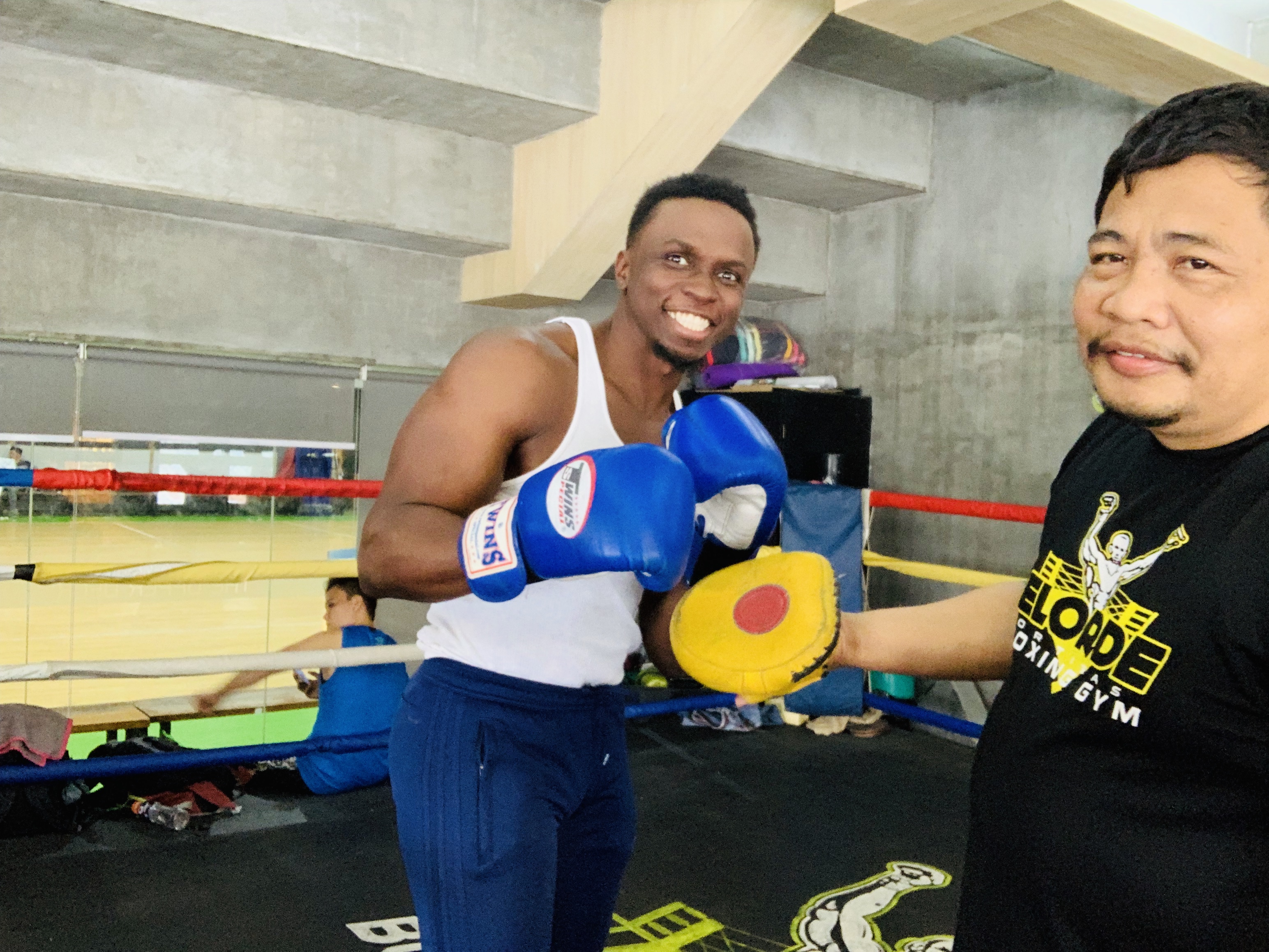 Clarence Bowen doing boxing padwork in Manila, Philippines in 2019